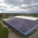 Commercial building with solar panels on the roof, generating renewable energy.