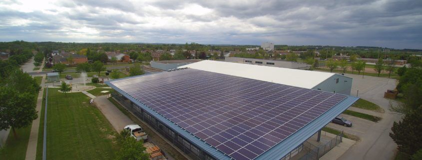 Commercial building with solar panels on the roof, generating renewable energy.