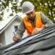 Roofing contractor answering questions from a homeowner during roof inspection.