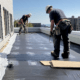 Commercial Flat Roof Roofers installing a PVC membrane roof to ensure durability and weather resistance