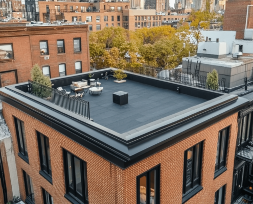 Flat roof roofers installing PVC membrane roofing on a commercial building