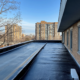 Flat roof waterproofing system installation on a commercial building in Ontario