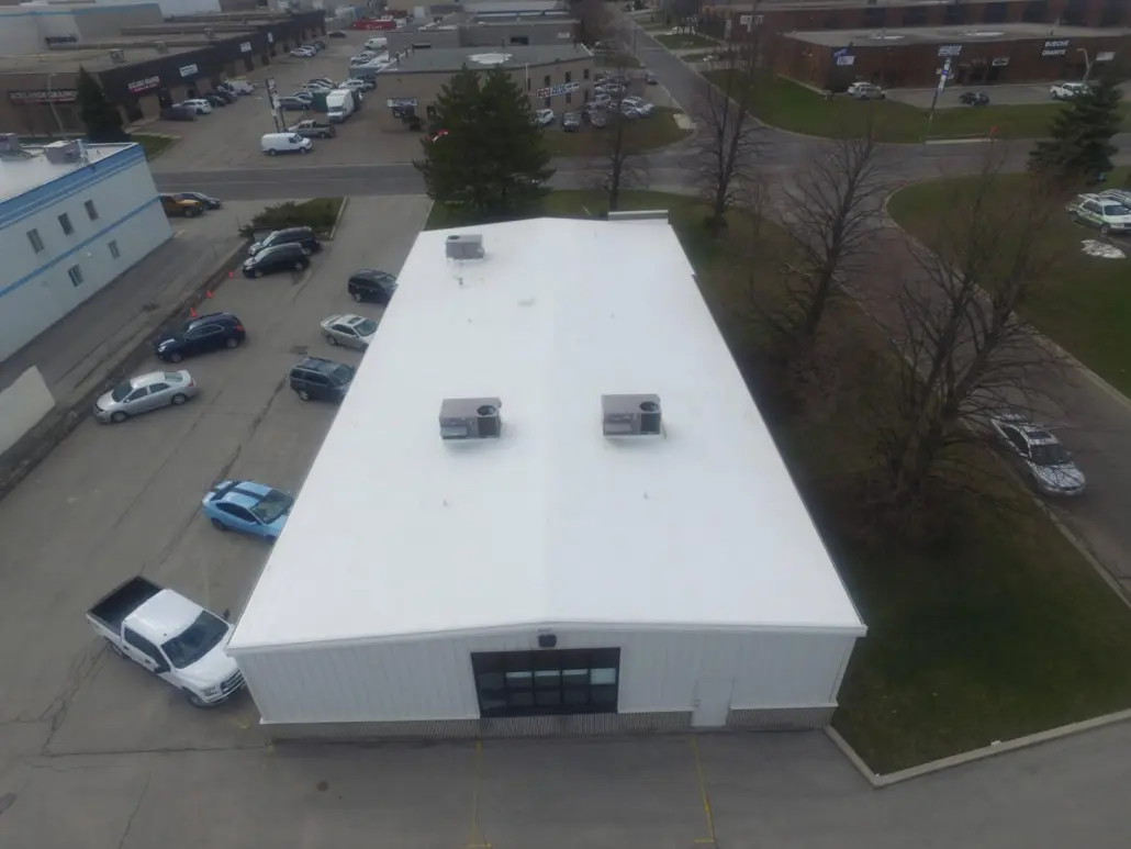 Aerial view of a single-storey industrial unit with a white membrane roof and two rooftop mechanical units