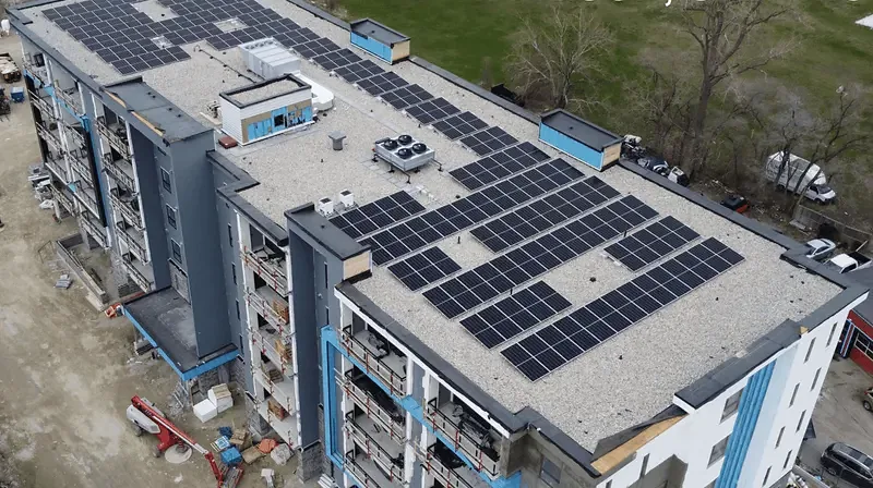 Aerial view of photovoltaic panels on a professionally managed multi-unit building