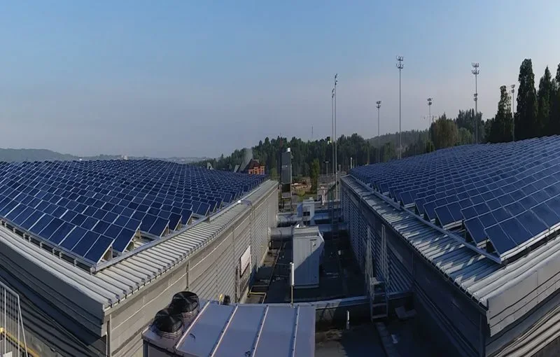 Rows of photovoltaic panels mounted on commercial roof structures