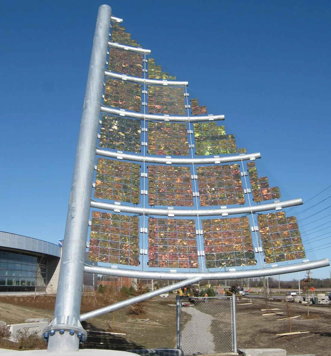 Architectural solar canopy structure beside a commercial facility