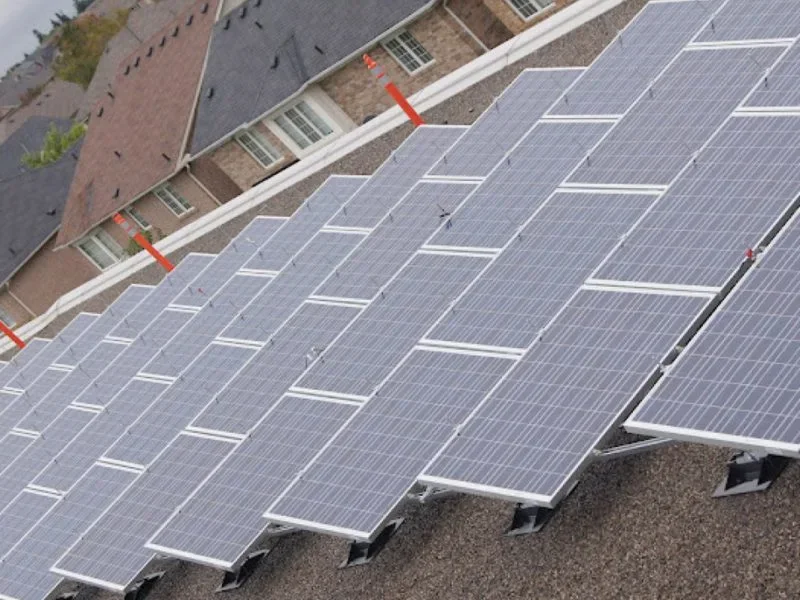 Photovoltaic panels installed across an institutional building roof