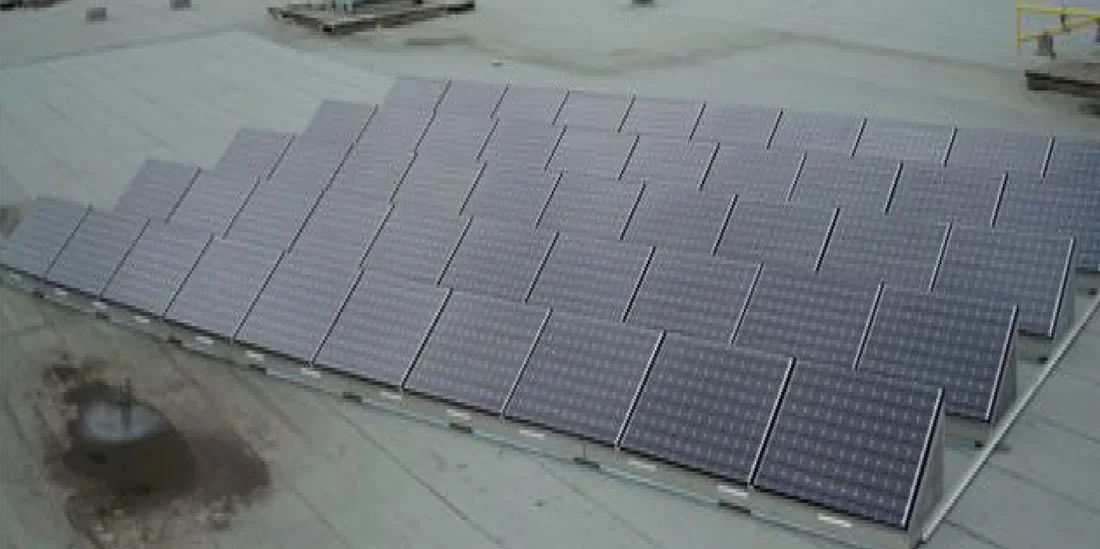 Wide view of solar modules installed across a low-slope commercial roof