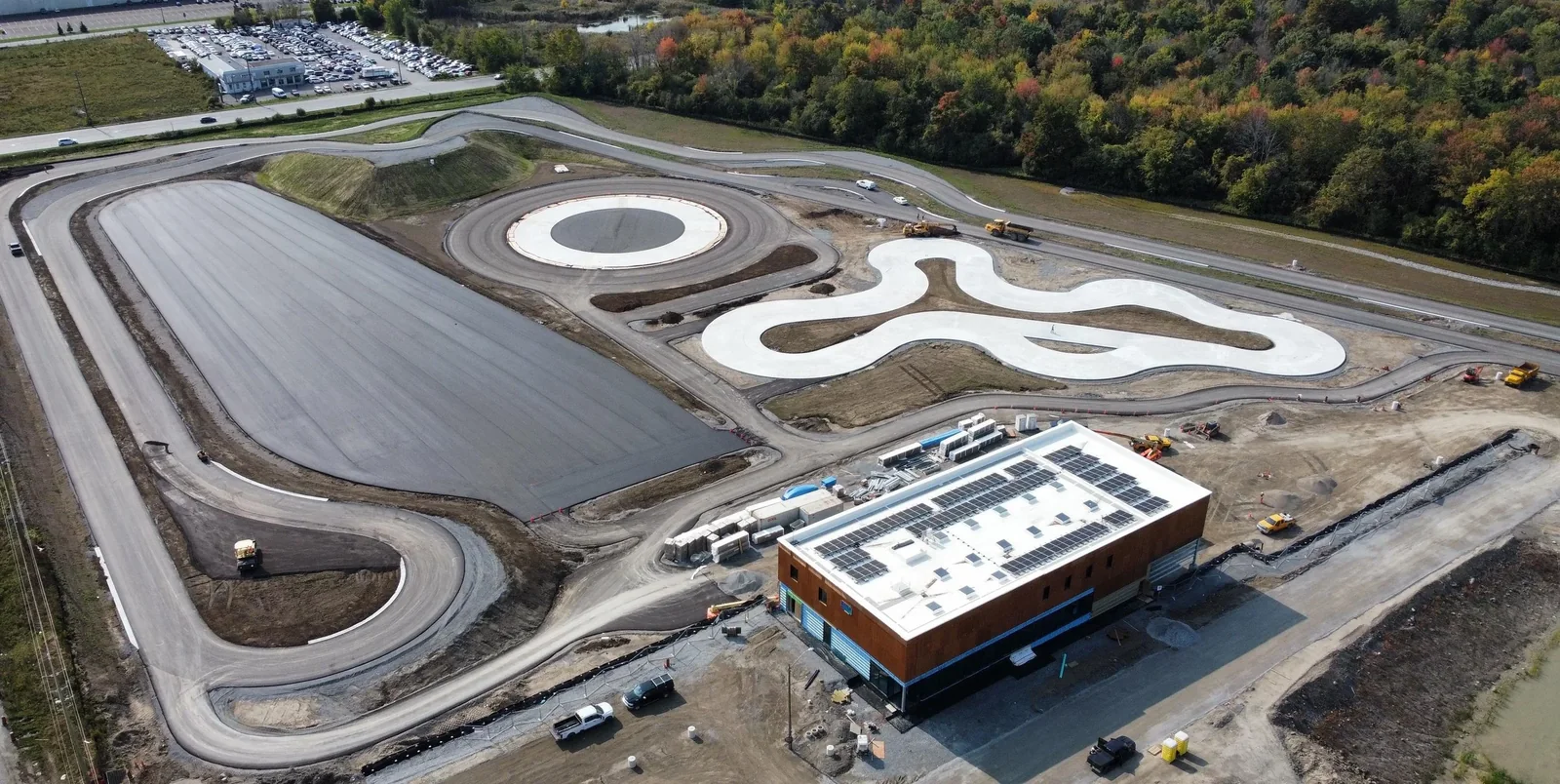 Aerial view of a commercial facility with photovoltaic panels on its flat roof
