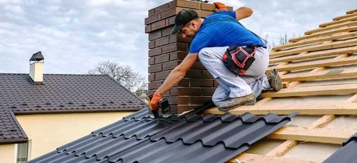 A homeowner discusses essential questions with a roofing contractor on-site.