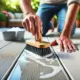 Scrubbing a grease stain on a DeckRite vinyl deck with a soft brush.